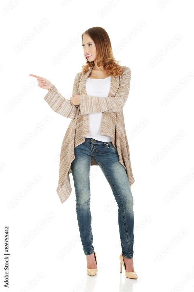 Happy smiling woman pointing aside. Happy smiling woman pointing aside.