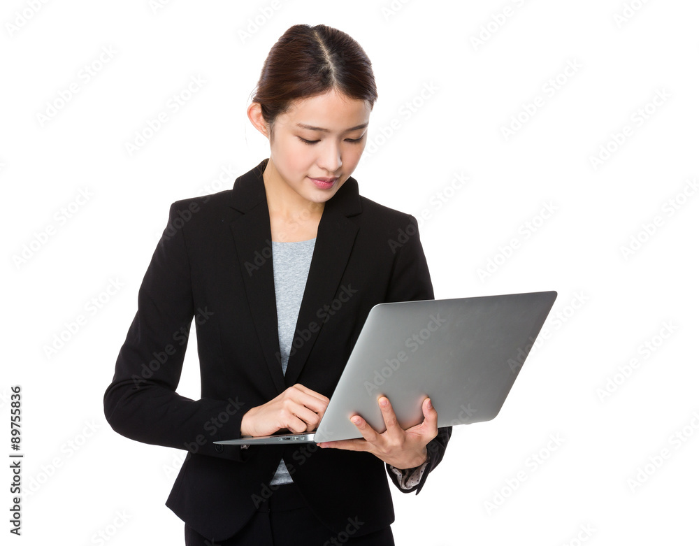 Asian businesswoman use of the notebook computer Asian businesswoman use of the notebook computer