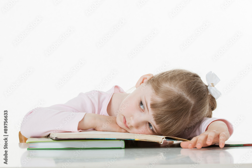 Thoughtful little girl with a books Thoughtful little girl with a books
