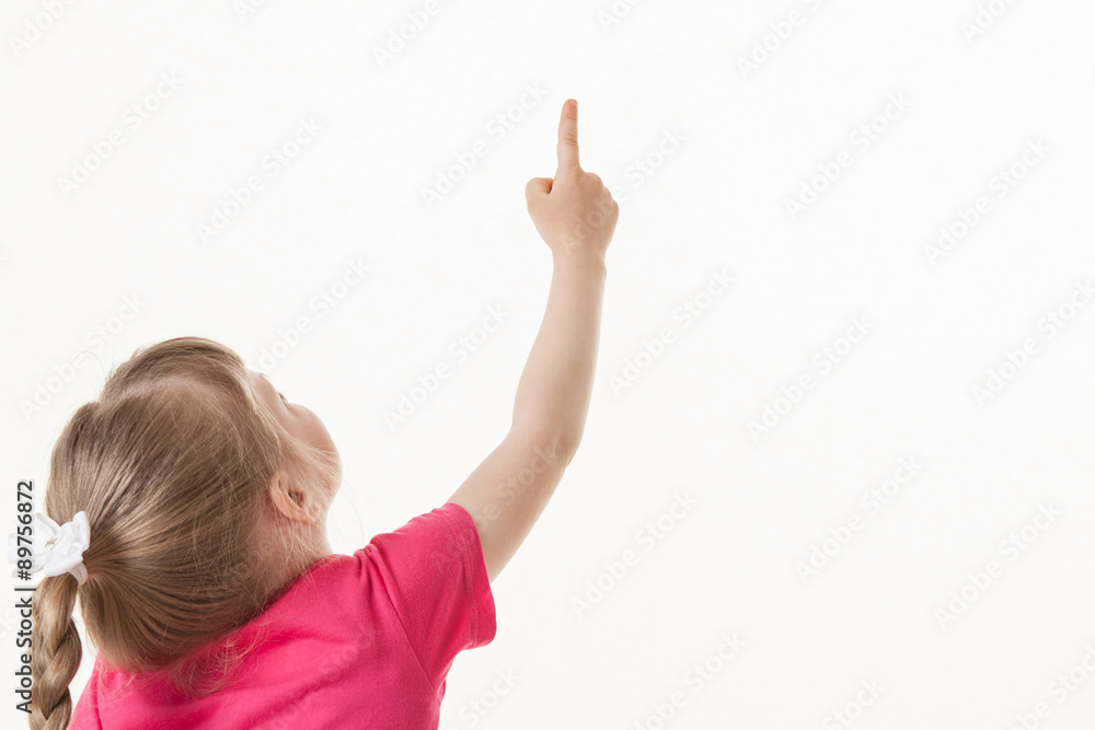 Caucasian little girl turning back and indicating something up Caucasian little girl turning back and indicating something up