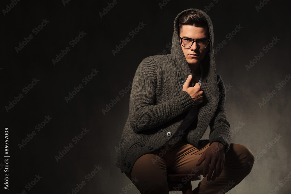 Fashion man pulling his sweater. Fashion man pulling his sweater.