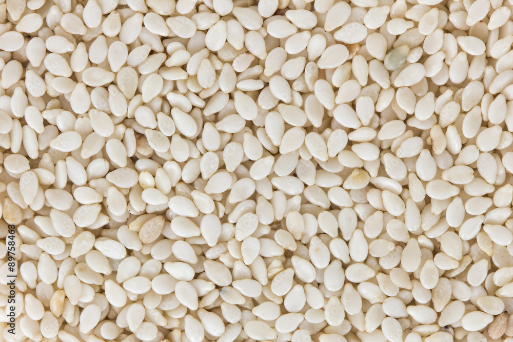 Background of sesame seeds with no shell, viewed from above.
