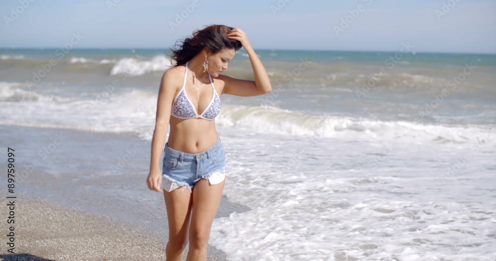 Playful woman playing in the surf on a beach Playful woman playing in the surf on a beach