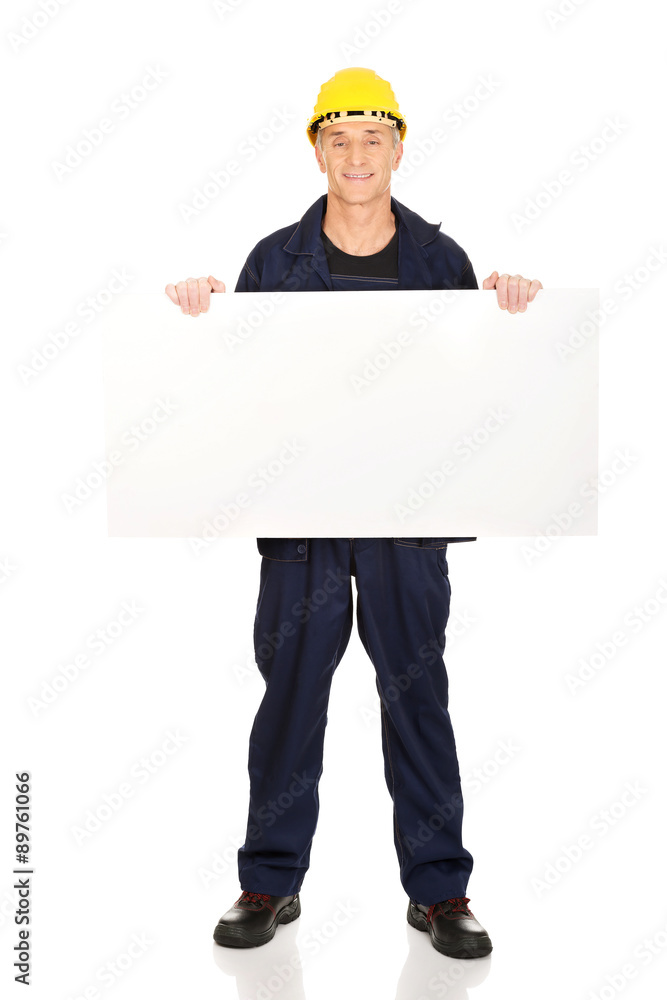 Full length happy worker presenting empty banner Full length happy worker presenting empty banner