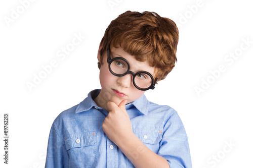 Portrait of handsome boy in round glasses thinking about photo