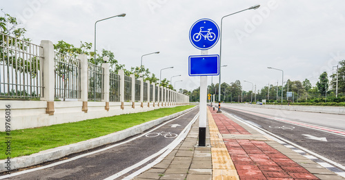 asphalt road and bike lane with sign