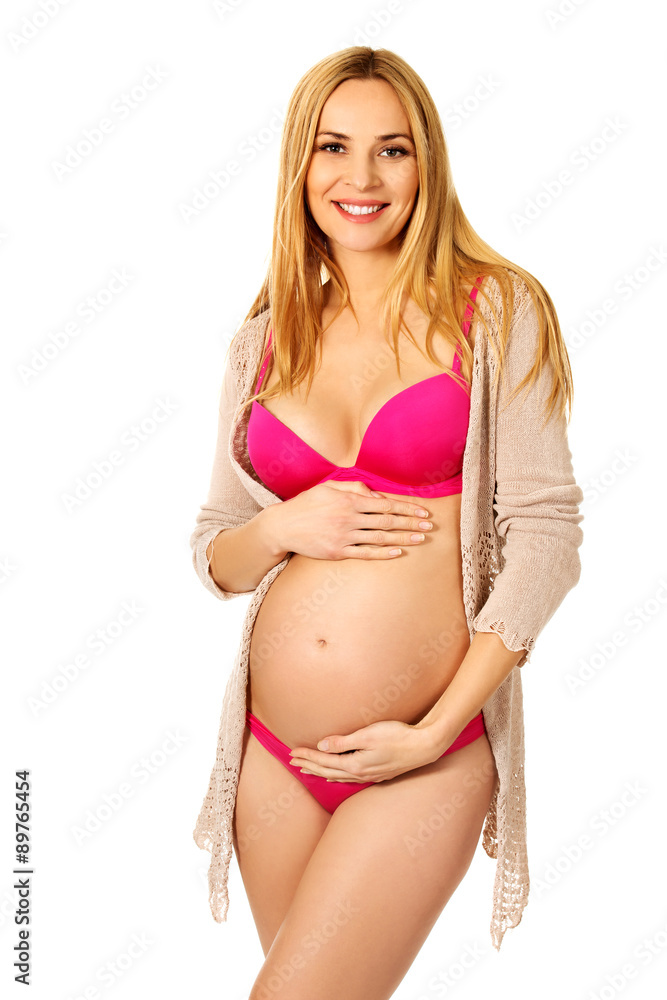 Fototapeta premium Pregnant woman in lingerie and cardigan