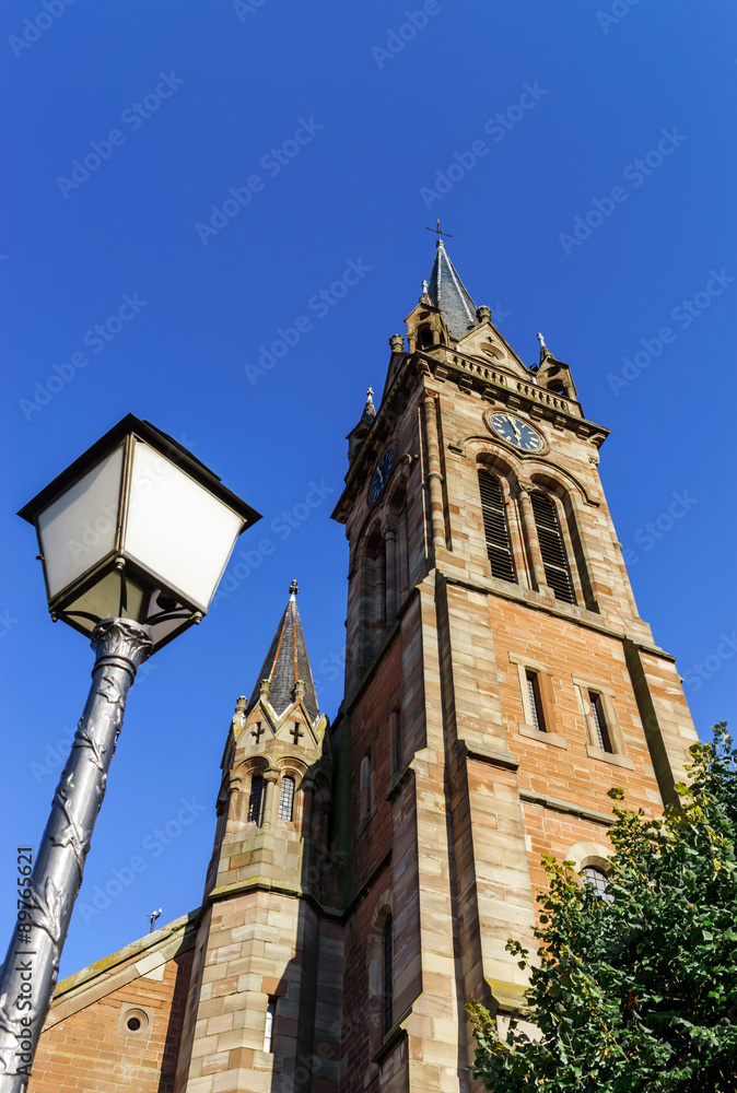 Very high belltower of cathedral in Dambach la Ville, France