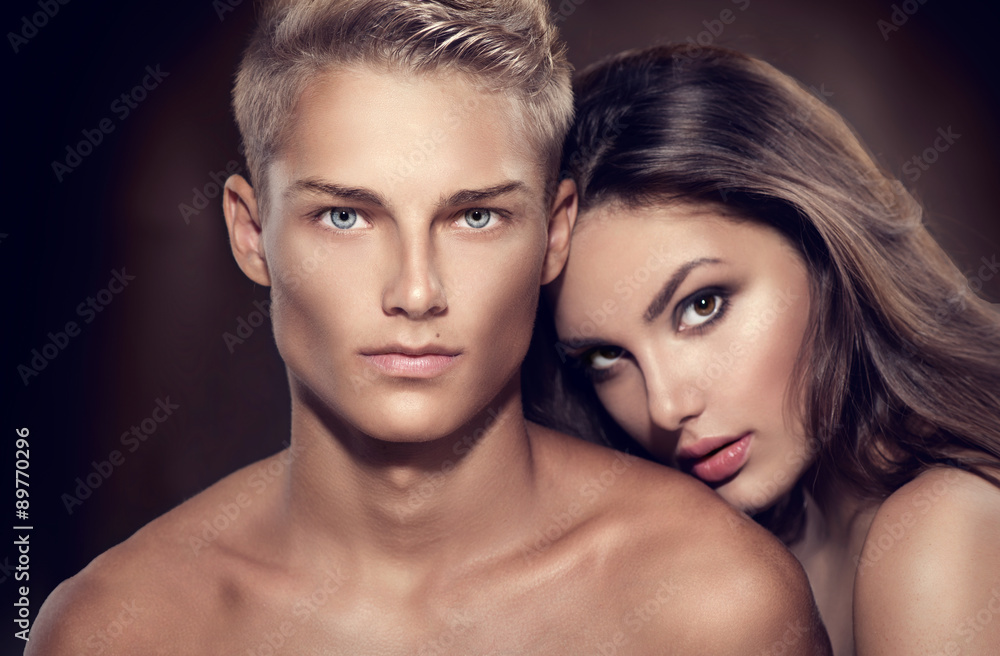 Beautiful sexy couple portrait. Model man with his girlfriend posing together Beautiful sexy couple portrait. Model man with his girlfriend posing together