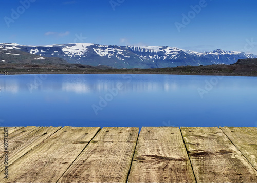 Panorama snow mountains and lake from wooden pier
