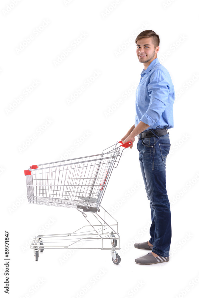 Young man with empty shopping cart, isolated on white Young man with empty shopping cart, isolated on white