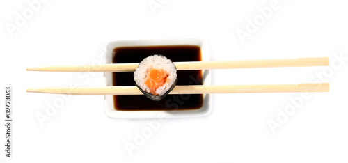 Roll with sauce and wooden sticks isolated on white