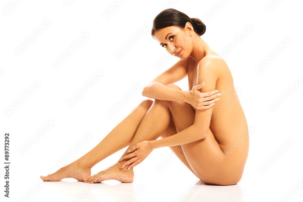 Fototapeta premium Nude woman sitting with knees close to the chest 