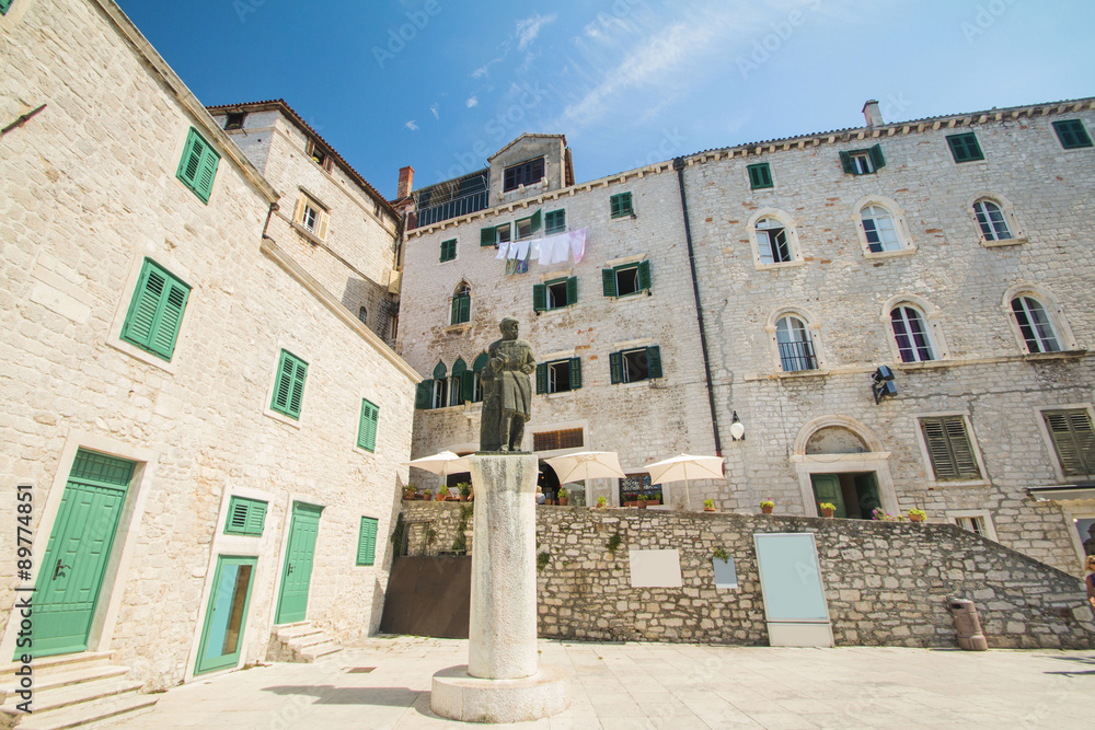 Statue and old traditional houses on public square in Sibenik, Croatia