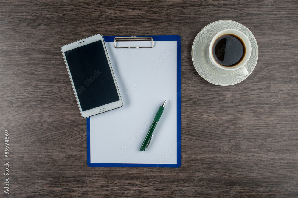 Tablet, paper and pen with a cup of coffee Tablet, paper and pen with a cup of coffee