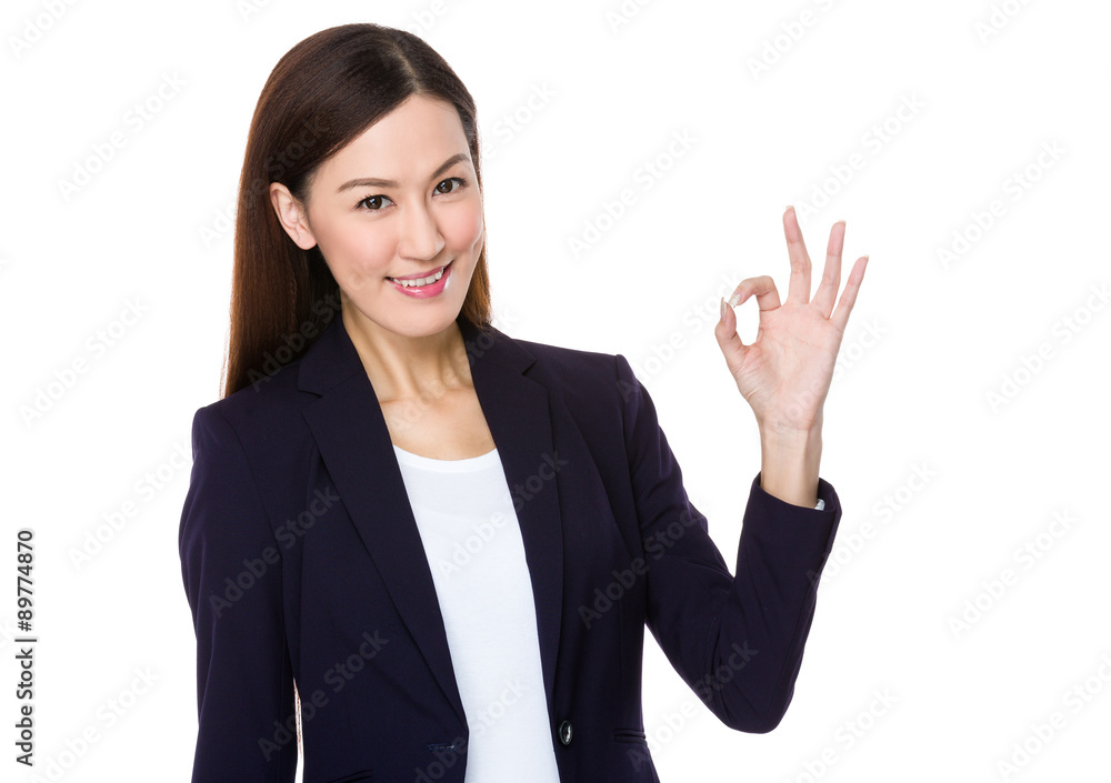 Asian young businesswoman with ok sign geature Asian young businesswoman with ok sign geature