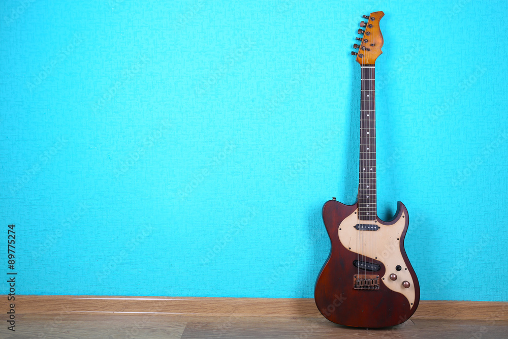 Fototapeta premium Electric guitar on blue wallpaper background