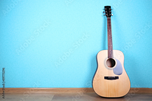 Classical guitar on blue wallpaper background