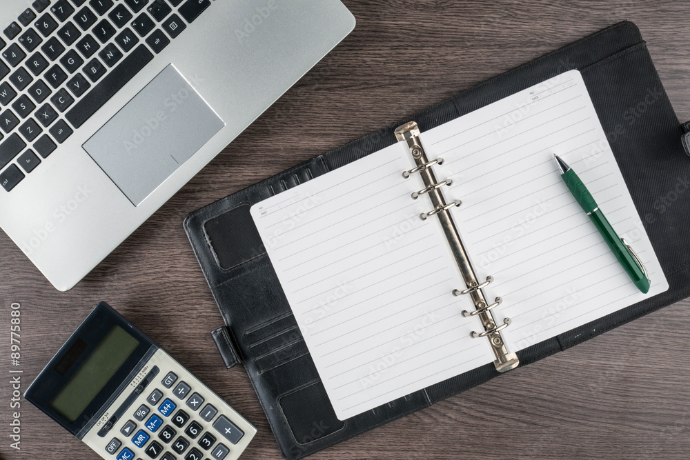 notebook and pen with calculator on the desk notebook and pen with calculator on the desk