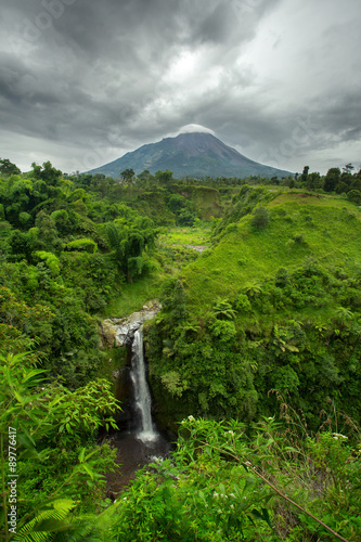 Kedung Kayang Waterfall and Mountain Merapi volcano. Java, Indon photo