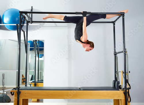 Pilates woman in cadillac walk over reformer