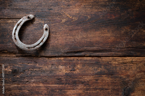 Fototapeta Naklejka Na Ścianę i Meble -  Old rusty horseshoe on vintage wooden board