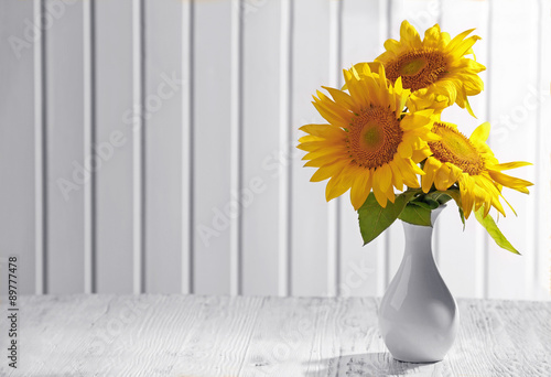 Fototapeta Naklejka Na Ścianę i Meble -  Beautiful bright sunflowers in vase on wooden background