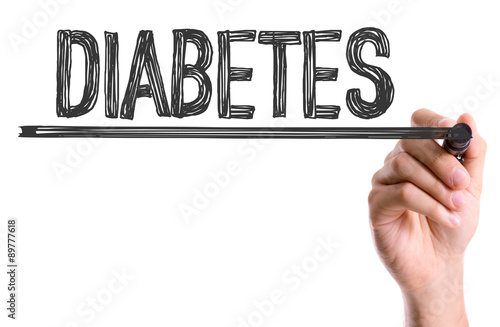 Hand with marker writing the word Diabetes photo