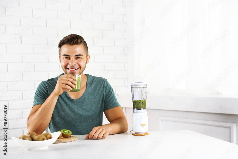 Young man drinking fresh kiwi juice Young man drinking fresh kiwi juice