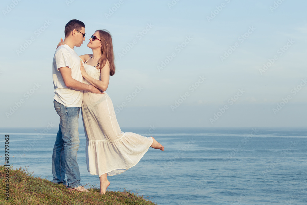 Loving couple standing on the beach at the day time.