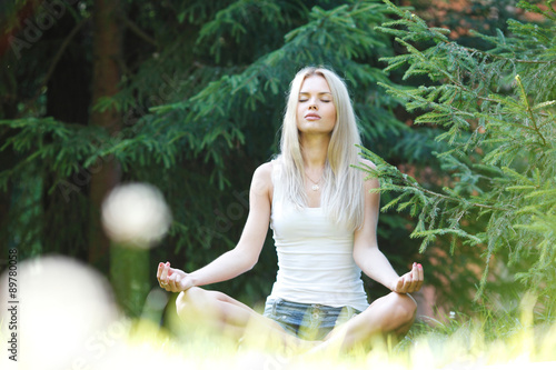 young blond woman in lotus pose