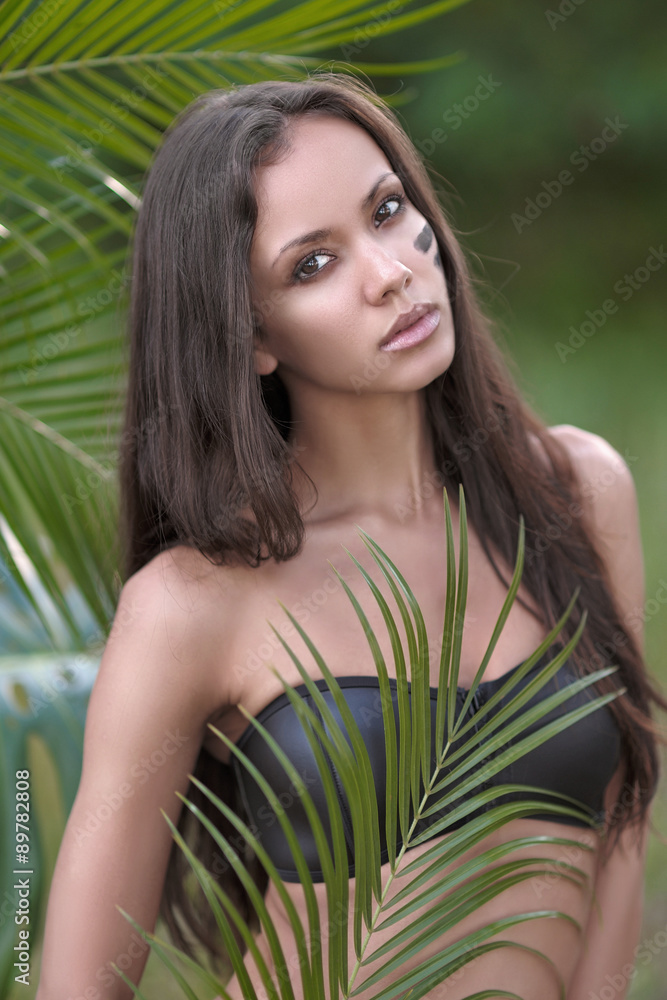 Naklejka premium portrait of a beautiful young girl in a swimsuit