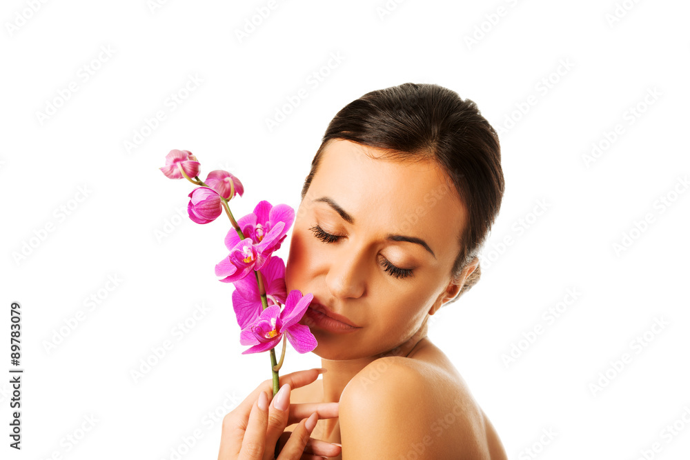 Topless woman with purple orchid branch