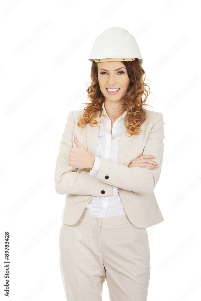 Businesswoman with thumbs up wearing helmet. Businesswoman with thumbs up wearing helmet.
