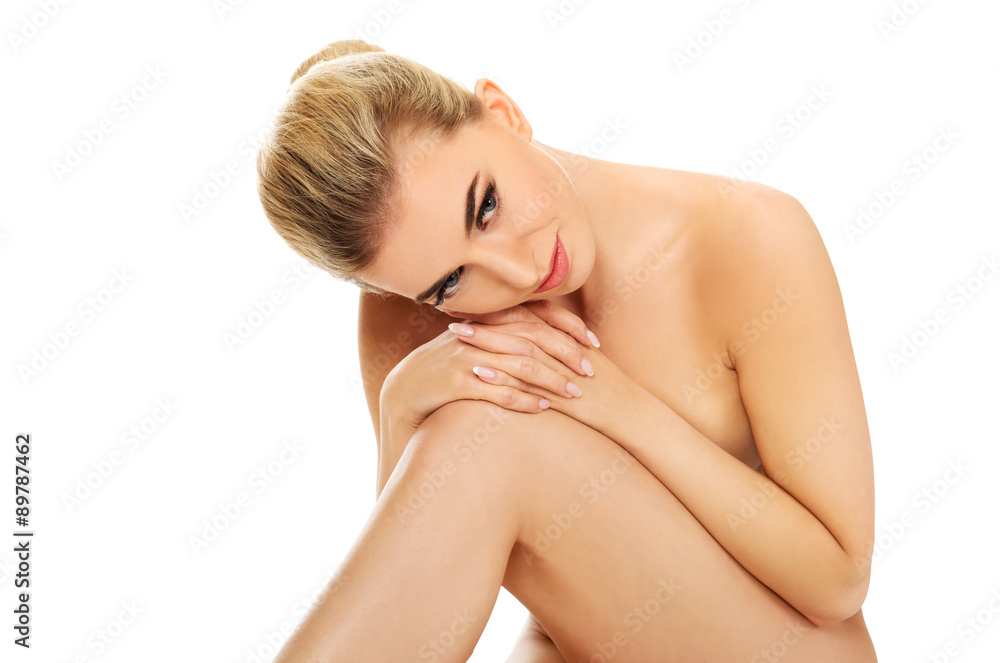 Young naked woman sitting on the floor. Young naked woman sitting on the floor.