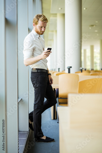 Wallpaper Mural Relaxed businessman having a break and using his phone Torontodigital.ca
