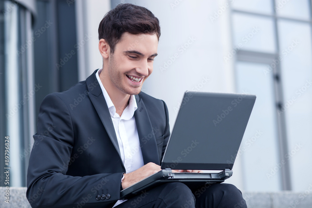 Attractive young man is using a laptop for work Attractive young man is using a laptop for work