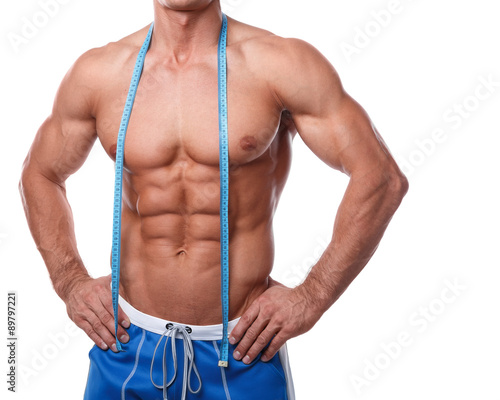 Slika na platnu Muscular male torso and measuring tape