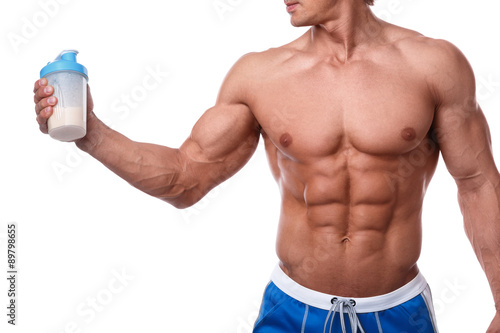 Muscular man with protein drink in shaker