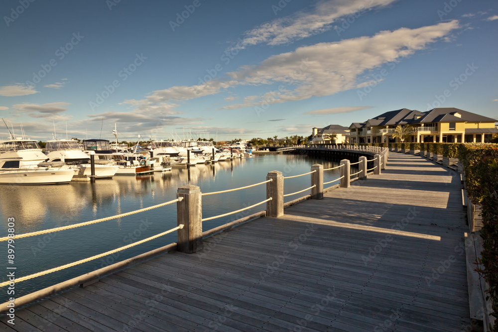 Beautiful wooden pathway in front of a marina