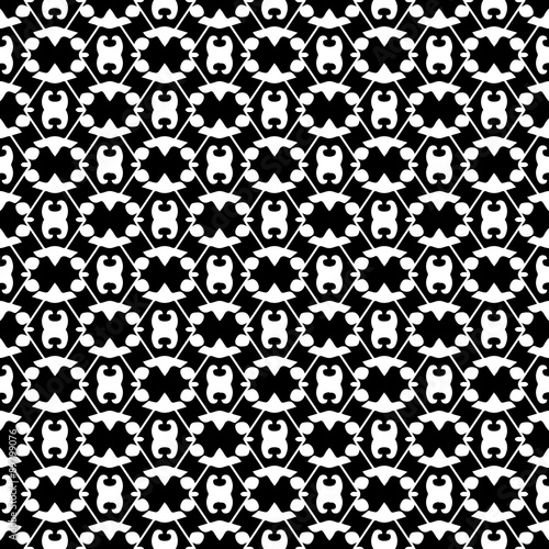 Abstract seamless pattern in black and white.  Hand drawn ornamental wallpaper or textile pattern with white motives on black background.