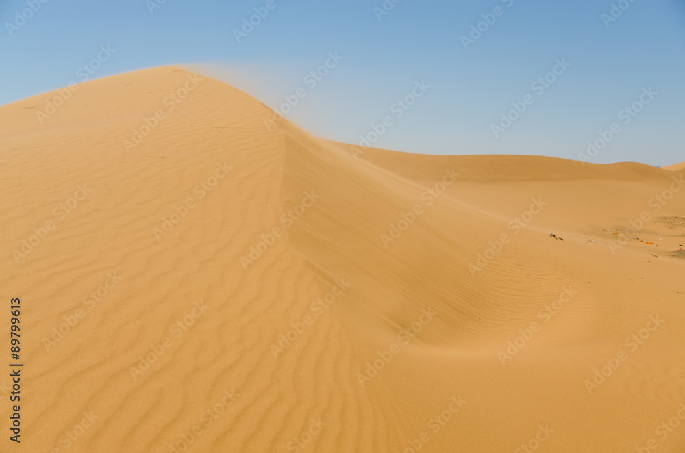 Sahara desert landscape with blue sky. Dunes background.