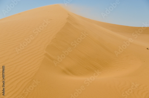 Sahara desert landscape with blue sky. Dunes background.