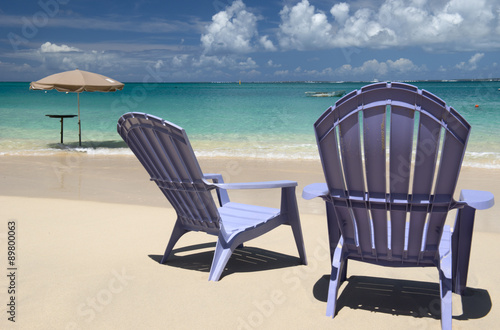 Chairs and umbrella at Grand Case beach  Saint Martin  Caribbean sea