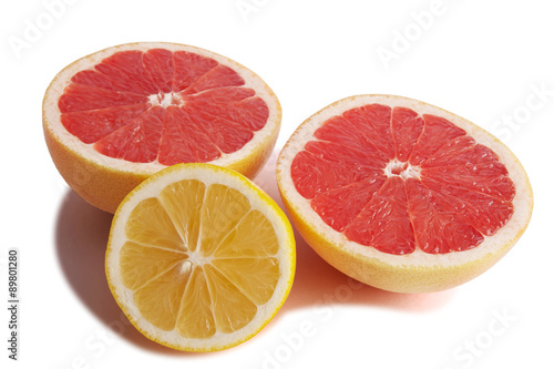 Fresh grapefruit and lemon cut in half.