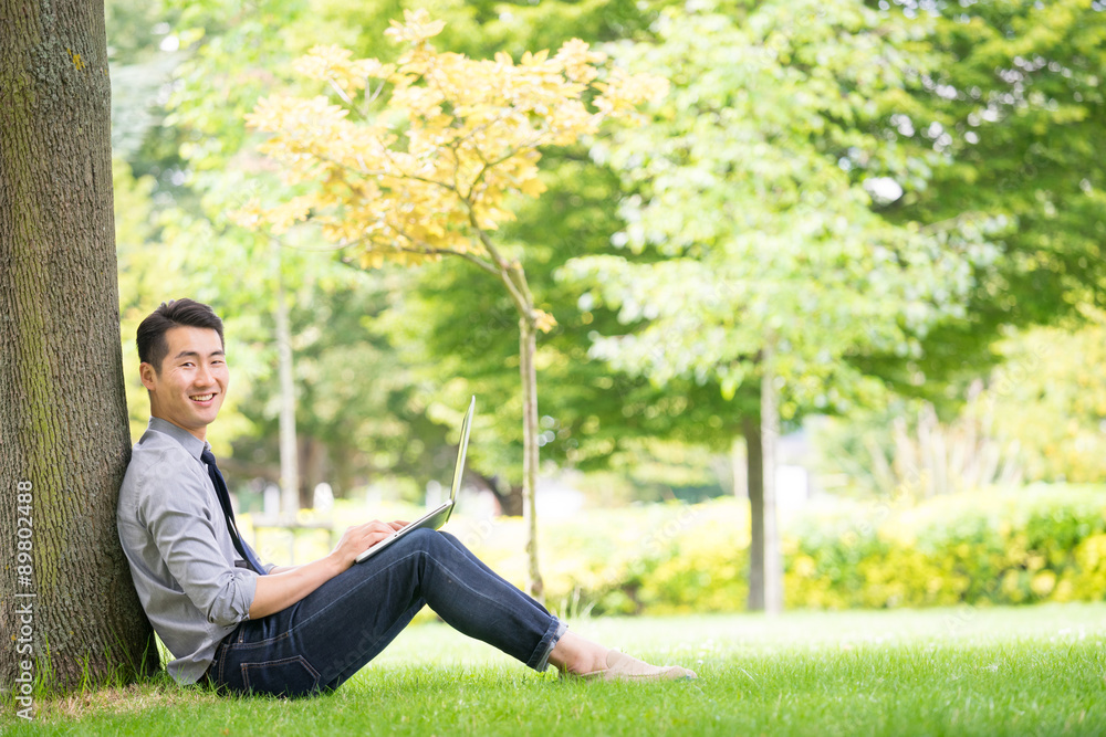 Young asian & success businessman using tablet, laptop, mobile p Young asian & success businessman using tablet, laptop, mobile p
