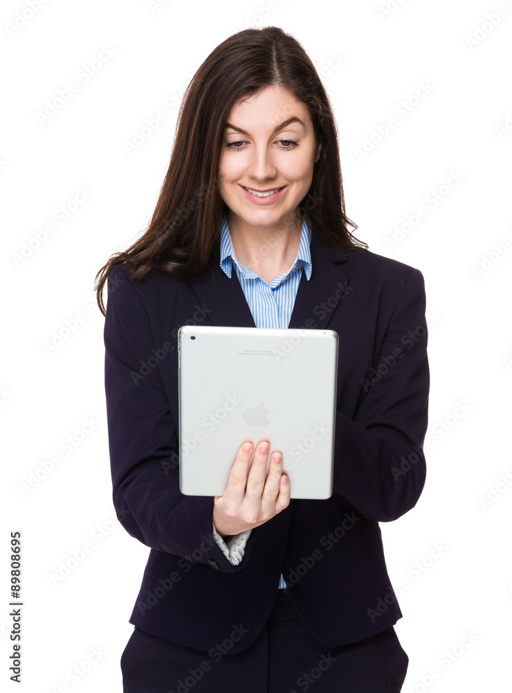 Brunette young businesswoman use of the tablet pc Brunette young businesswoman use of the tablet pc
