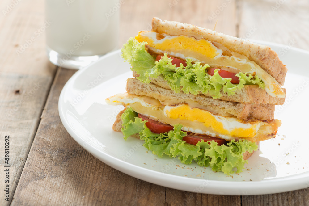 Sandwichs fried egg with cheese and milk on wood table. Sandwichs fried egg with cheese and milk on wood table.