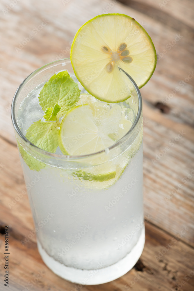 Cold fresh lemonade soda drink on a wooden background. Cold fresh lemonade soda drink on a wooden background.