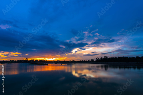 Fototapeta Naklejka Na Ścianę i Meble -  Sunset landscape with blue sky at the calm lake